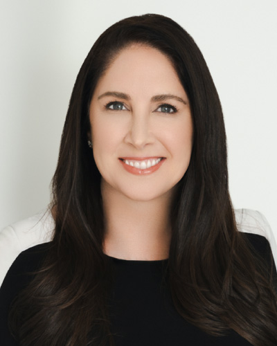 Jennifer Rochlis | ISDC 2026 Professional headshot of a smiling woman with long dark hair against a light background.